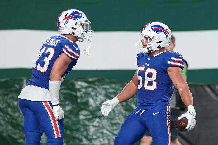 Bernard and Milano celebrate a big play during the season-opener against the New York Jets on Sept. 11.